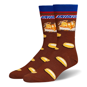Brown crew socks featuring a blue cuff, the Snickers logo, a candy bar cross-section, and a scattered peanut pattern.