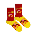 Flat lay of Starburst candy socks displaying red legs, bright yellow feet, classic logos, and a layered drop pattern.