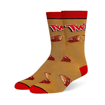 Crew socks with a golden caramel background, red cuffs, heels and toes, featuring the Twix logo and broken chocolate bars.