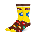 Yellow and brown M&M's crew socks with the classic logo on the leg and a pattern of colorful candy pieces on the dark foot.