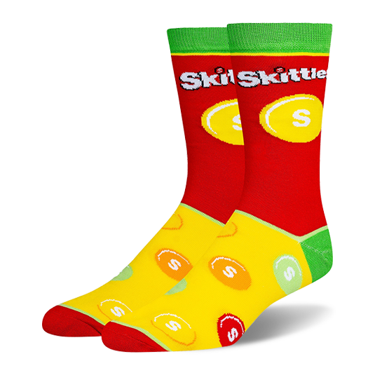 Novelty socks with a red top, green cuff, and yellow foot. Features the Skittles logo and a scattered colorful candy pattern.