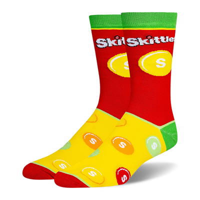 Novelty socks with a red top, green cuff, and yellow foot. Features the Skittles logo and a scattered colorful candy pattern.