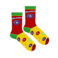 Flat lay of Skittles socks showing a red upper with a large purple candy, green cuffs, and a yellow foot with colorful drops.