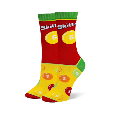 Crew socks with a red upper featuring the Skittles logo, green cuffs and heels, and a yellow foot with scattered candy pieces.