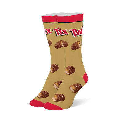 Gold crew socks with a red top, toe, and heel, featuring the Twix logo and a pattern of broken chocolate caramel bars.