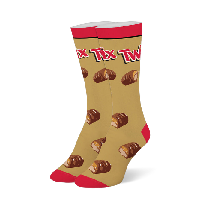 Gold crew socks with a red top, toe, and heel, featuring the Twix logo and a pattern of broken chocolate caramel bars. }}