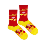 Flat lay of two Starburst socks showing the red upper with retro logo and candies, and a yellow foot with colorful drops.