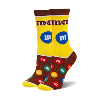 Pair of crew socks with an M&M's design.  Yellow and brown background with colorful M&M candies and the M&M's logo.