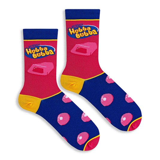 Flat lay of two pink and blue Hubba Bubba socks showing the yellow logo, a chunk of pink gum, and round pink bubbles.
