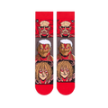 Flat lay of Attack on Titan socks showing the full front design with stacked Titan faces and bright red toes and cuffs.