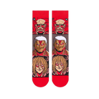 Flat lay of Attack on Titan socks showing the full front design with stacked Titan faces and bright red toes and cuffs.