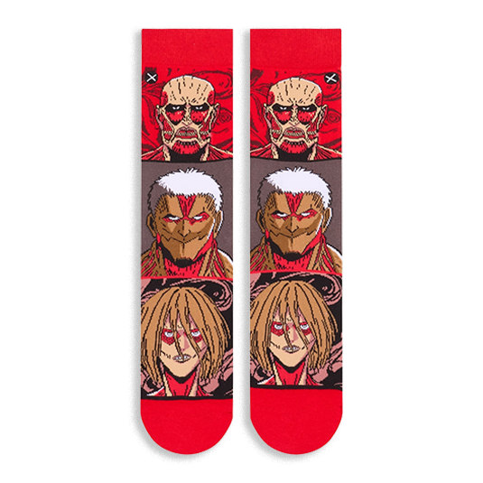 Flat lay of Attack on Titan socks showing the full front design with stacked Titan faces and bright red toes and cuffs.