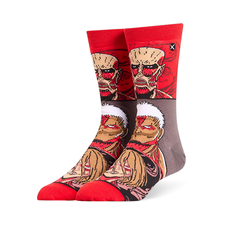 Red and grey crew socks displaying stacked Attack on Titan faces, featuring the Colossal, Armored, and Female Titans.