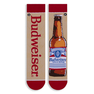 Flat lay of mismatched tan socks. One features vertical red Budweiser text, the other a full brown beer bottle illustration.