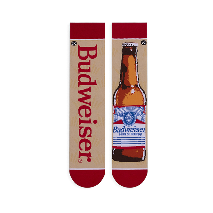 Flat lay of mismatched tan socks. One features vertical red Budweiser text, the other a full brown beer bottle illustration.