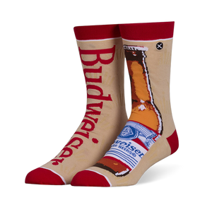 Mismatched tan crew socks with red accents. Left sock has red Budweiser text, right sock shows a brown beer bottle.