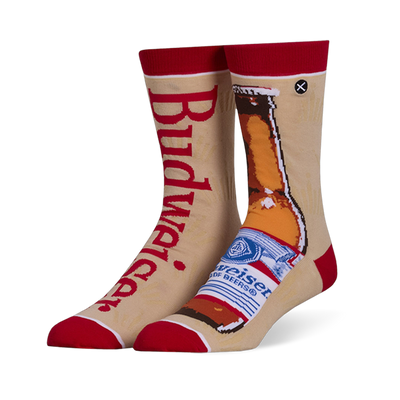 Mismatched tan crew socks with red accents. Left sock has red Budweiser text, right sock shows a brown beer bottle.
