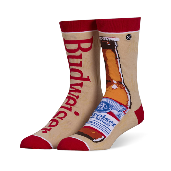 Mismatched tan crew socks with red accents. Left sock has red Budweiser text, right sock shows a brown beer bottle.