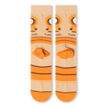 Flat lay back view of beige socks displaying the wrapped orange stripes, orange heel block, and small brown copyright text.