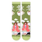 Flat lay of two olive green socks showing a person in a pink blanket, black cat, clouds, and bold white text.