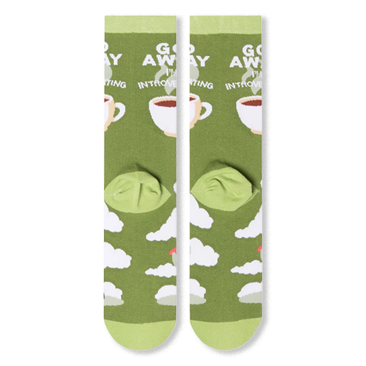Flat lay of the back of two olive green socks displaying fluffy white clouds and a steaming coffee cup.