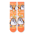 Front flat lay of orange socks showing a repeating pattern of a sleepy penguin, coffee cups, flowers, and white text.