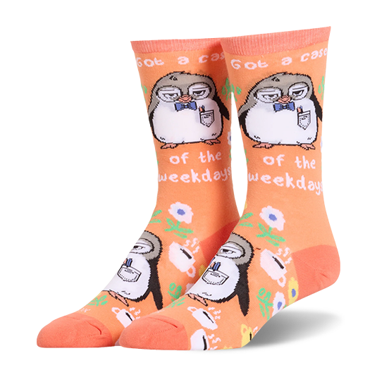 Orange crew socks showing a tired penguin in glasses, coffee cups, flowers, and the text Got a case of the weekdays.