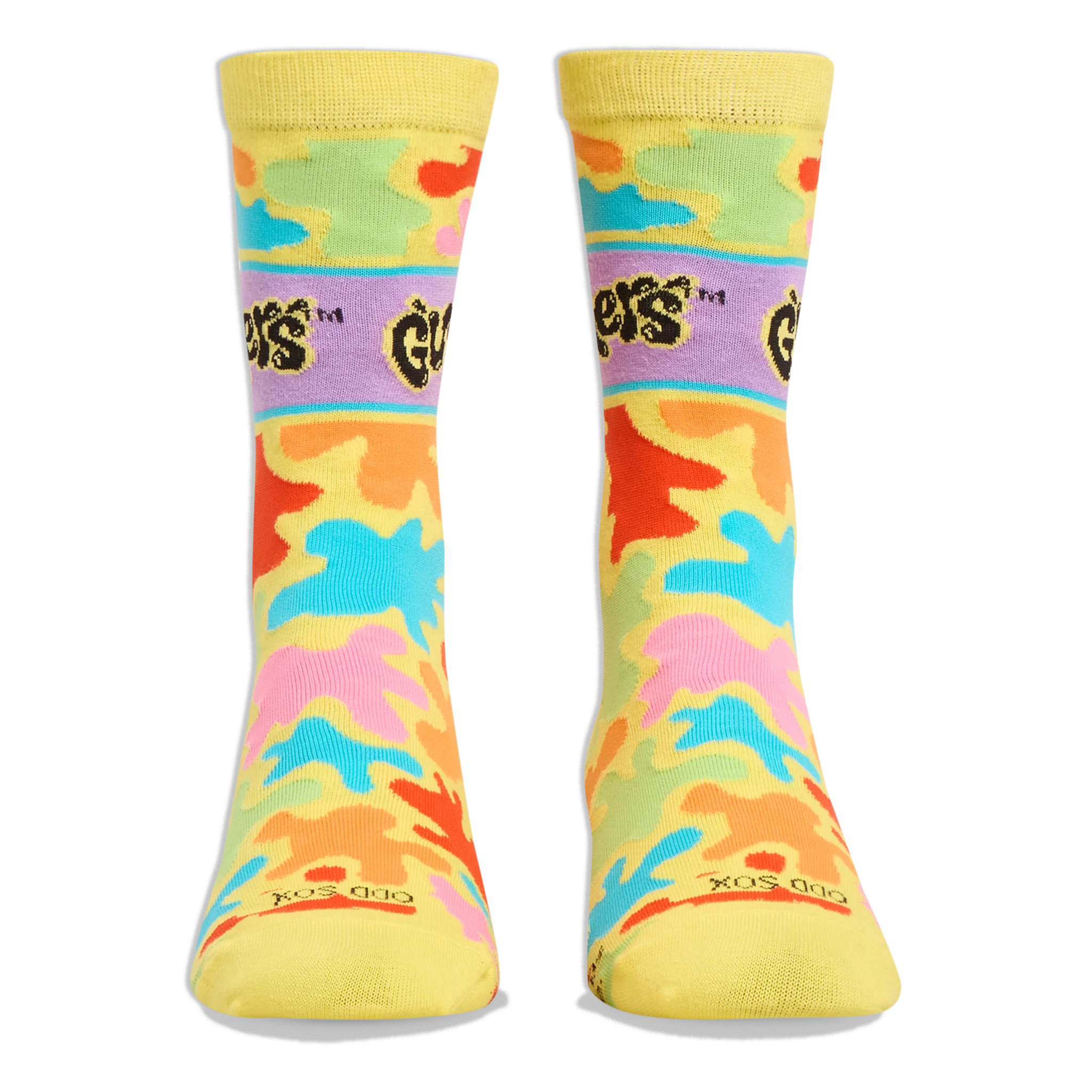 Front view of yellow crew socks showing the purple Gushers logo band on the shins and colorful neon splatters throughout.
