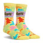 Side angle view of yellow crew socks with a colorful splash pattern in bright neon colors and the black Gushers logo.