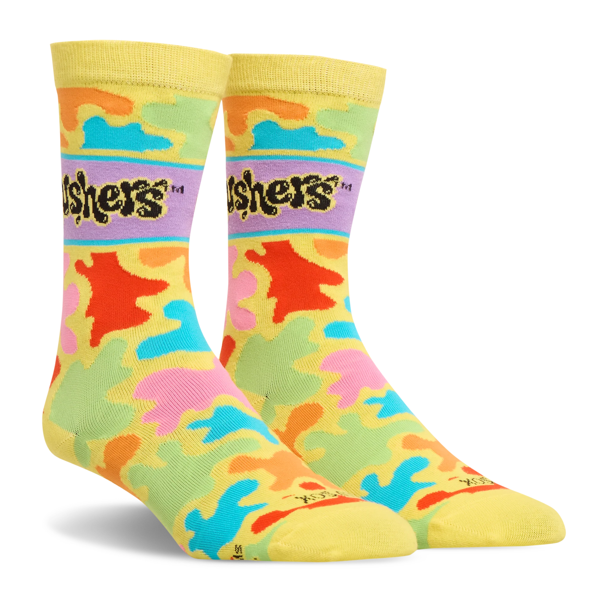 Side angle view of yellow crew socks with a colorful splash pattern in bright neon colors and the black Gushers logo.