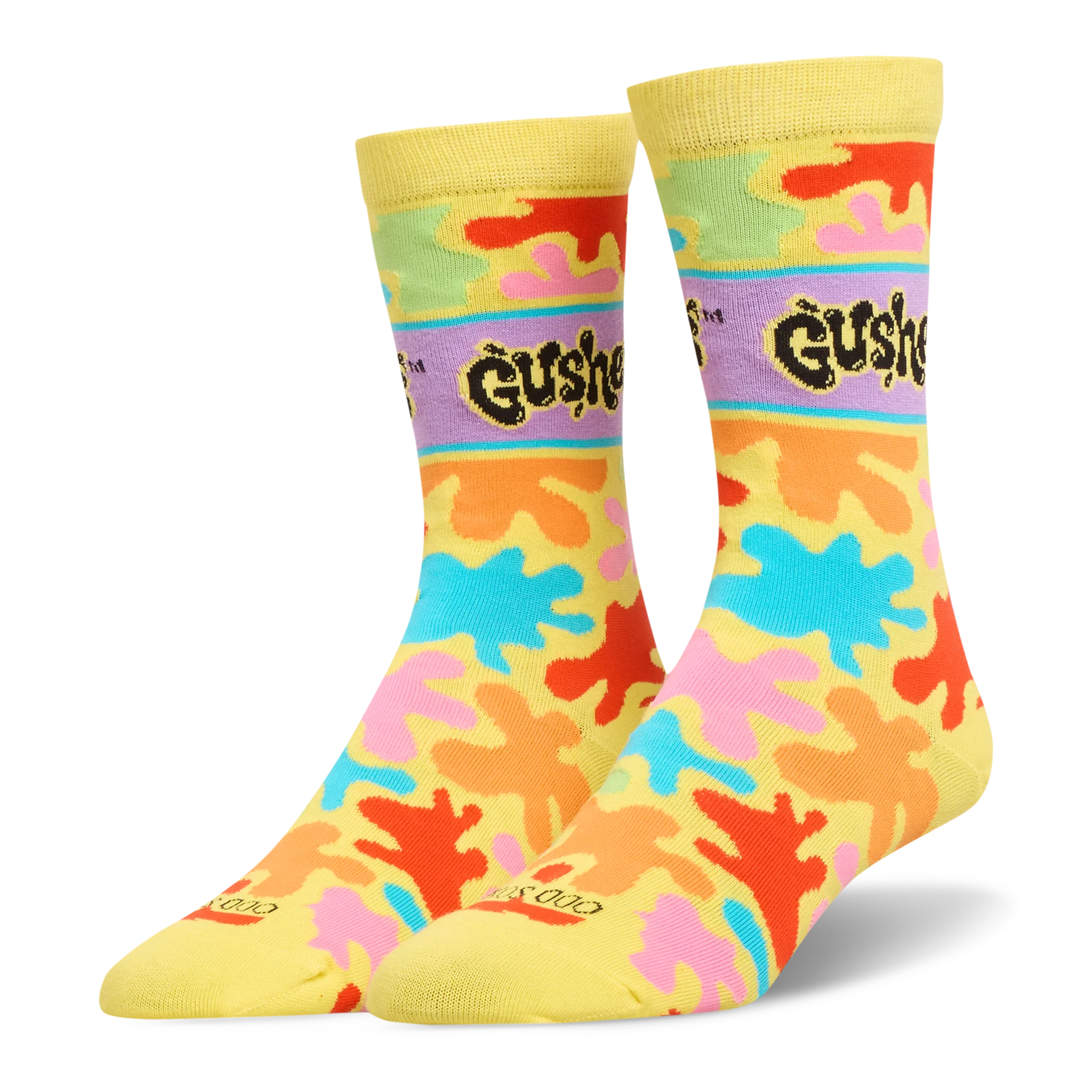 Yellow crew socks featuring bright orange, pink, blue, and green splatters, plus a purple band with the black Gushers logo.
