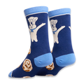 Angled view of dark blue socks highlighting the light blue heel and back of the Pillsbury Doughboy and cinnamon roll design.