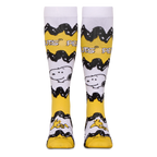 Front view of tall yellow and white Peanuts socks showing the black zigzag stripe, Snoopy, Woodstock, and Peanuts text.