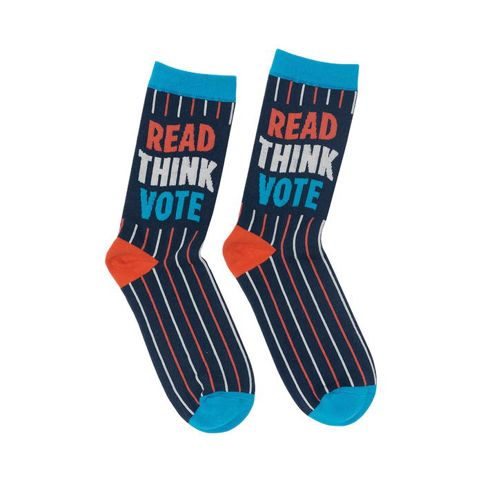 a pair of navy blue adult socks with white stripes and the words 'read think vote' in red, white, and blue.