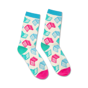 Pair of crew socks with a white background and teal and pink open book designs. The socks have light blue cuffs and hot pink heels and toes.