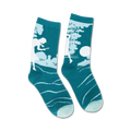 A pair of teal crew socks with a white silhouette of Nancy Drew solving a mystery.  Subtle wave pattern at the bottom.