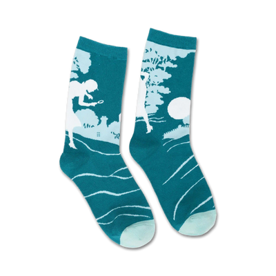 A pair of teal crew socks with a white silhouette of Nancy Drew solving a mystery.  Subtle wave pattern at the bottom.