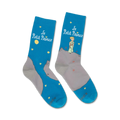 Pair of crew socks in teal blue and grey, depicting The Little Prince standing on an asteroid against a starry night sky.  The title 'Le Petit Prince' is featured on the socks.