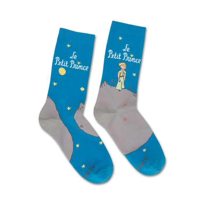 blue crew socks feature the little prince standing on a mountain range under a starry night sky.    }}