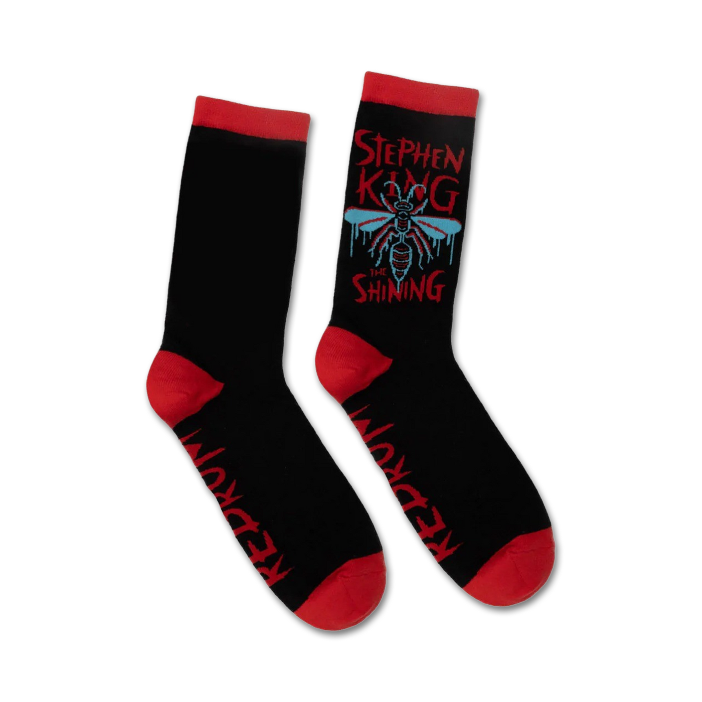 Pair of black crew socks with red cuffs. Features a graphic design of a fly, dripping text that says 'Stephen King The Shining', and 'Redrum' on the sole.