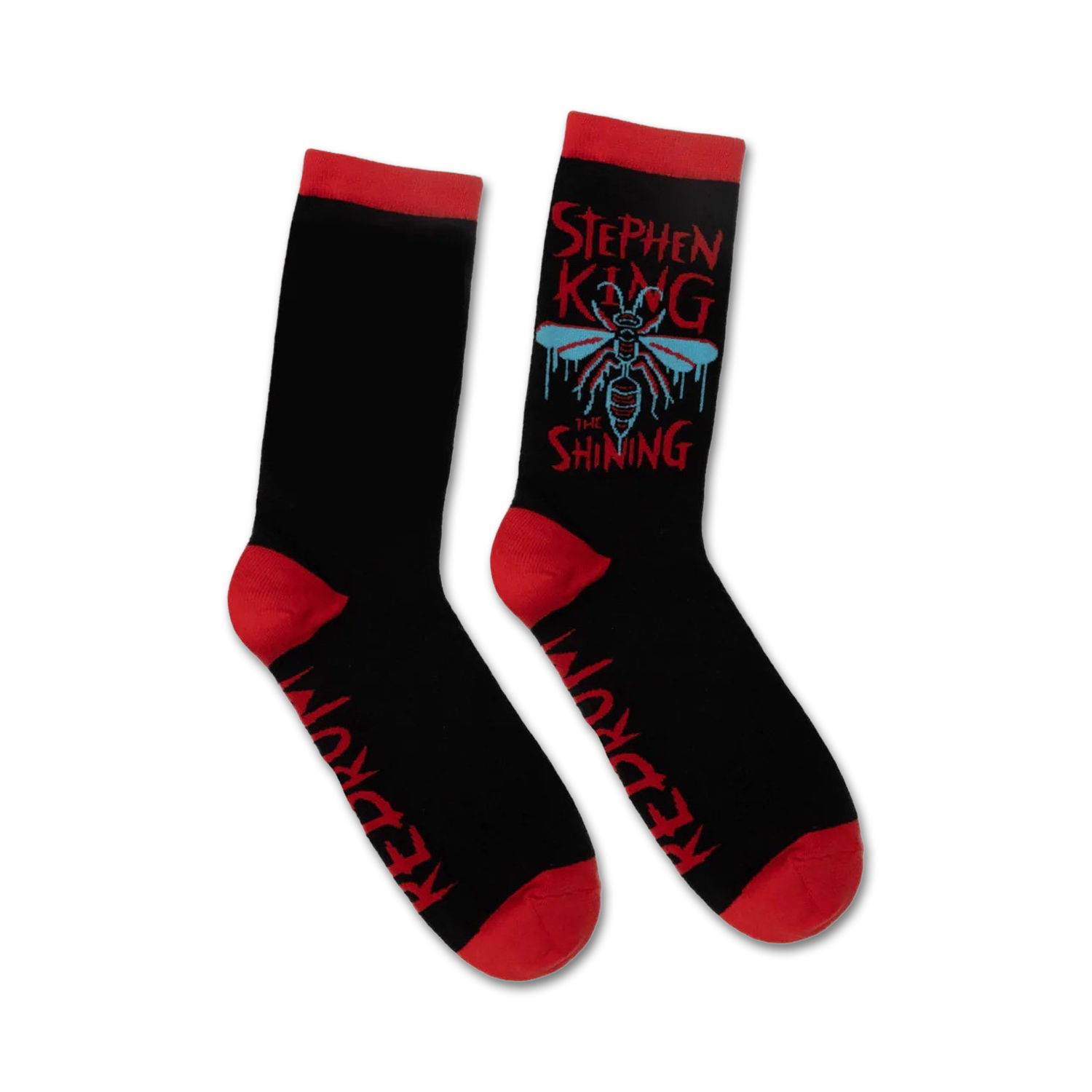 Pair of black crew socks with red cuffs. Features a graphic design of a fly, dripping text that says 'Stephen King The Shining', and 'Redrum' on the sole.