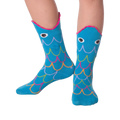 Lifestyle photo showing Fish Wide Mouth socks on a person's legs against a black background.