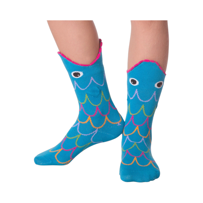 Lifestyle photo showing Fish Wide Mouth socks on a person's legs against a black background.