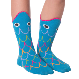 A pair of blue socks with a fish design. The socks have a pink toe and heel, and the fish has black eyes and a pink mouth. The scales on the fish are multi-colored.