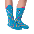 Another lifestyle shot of the Fish Wide Mouth socks on legs against a black background; different pose.