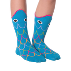 Another lifestyle shot of the Fish Wide Mouth socks on legs against a black background; different pose.
