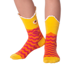 Lifestyle shot of Piranha Wide Mouth socks on a person's legs against a black background.