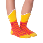 Another lifestyle shot of Piranha Wide Mouth socks on a person's legs against a black background, slightly different angle.