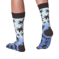 Back view of Palm Socks on a person's legs against a black background.
