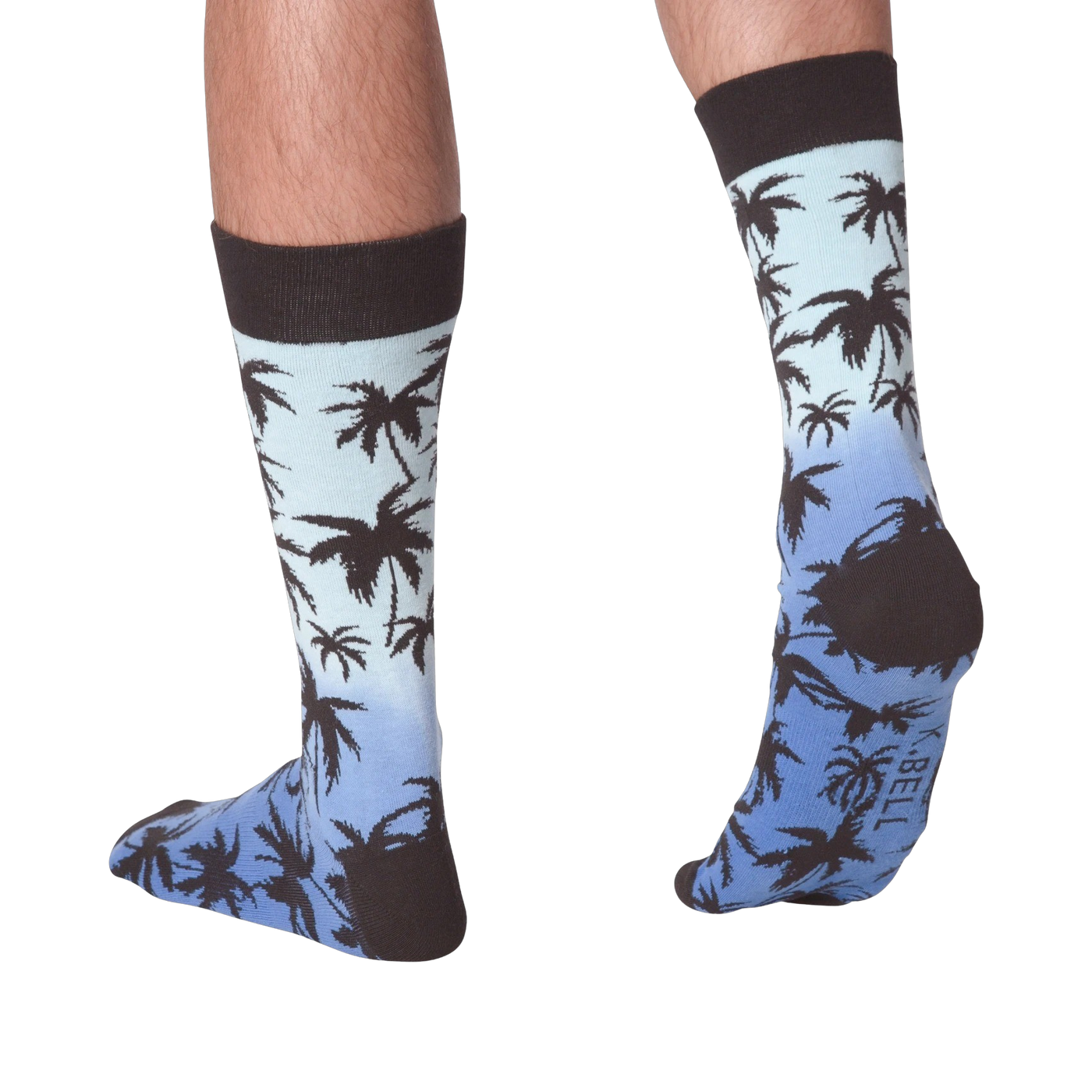 Back view of Palm Socks on a person's legs against a black background.